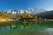 Stand-up paddling on the Eibsee below the Zugspitze, Werdenfelser Land, Bavaria, Germany