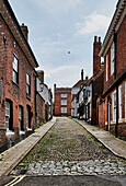 A streetscape of a laneway with residences and shops in Rye, East Sussex, UK.