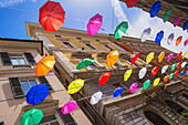 Brightly coloured floating umbrellas, Genoa, Liguria, Italy