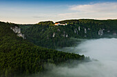 View from Eichfelsen to Wildenstein Castle with morning fog, sunrise, near Irndorf, Obere Donau Nature Park, Upper Danube Valley, Danube, Swabian Alb, Baden-Württemberg, Germany