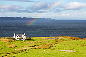 Kalnakill, traditional croft house, rainbow, Applecross peninsula, Skye in background, Wester Ross, west coast, Scotland UK