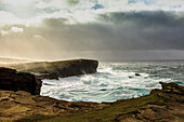 Storm, surf breaker, Yesnaby cliff, sunbeam through clouds, cliffs, Orkney, Scotland UK