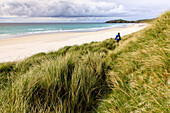 Hike, sandy beach, grass dunes, Barra Island, Outer Hebrides, Scotland UK
