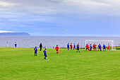 Football players in front of the sea, Port Charlotte, Islay, Inner Hebrides, Scotland UK