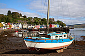 Sailboat and colorful house facades in Tobermory, Mull, Inner Hebrides, Scotland UK