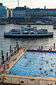 Allas Sea Pool, people bathing in the pool embedded in the harbor basin, Helsinki, Finland