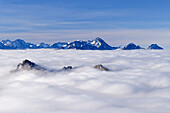 View of sea of fog and the mountain peaks of the Heuberg, in the background Spitzing area and Wendelstein, from Feichteck, Chiemgau Alps, Upper Bavaria, Bavaria, Germany
