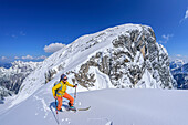 Woman on ski tour ascends through the Steintal, Steintal, Hochkalter, Berchtesgaden Alps, Berchtesgaden National Park, Upper Bavaria, Bavaria, Germany