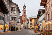 Obermarkt with Church of St. Peter and Paul at dusk, Mittenwald, Bavaria, Germany