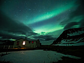 Northern lights over house, aurora borealis, Hornvik Bay, Westfjords, Europe