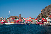 Fjällbacka harbor and skyline by day with sun and blue sky in Sweden