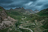 Julier Pass in summer with a dramatic cloudy sky in the Swiss Alps in Graubünden from above