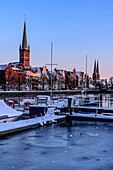 Icy jetty at Radisson Blu Senator Hotel overlooking St. Petri Church and Cathedral, Lübeck, Bay of Lübeck, Schleswig Holstein, Germany