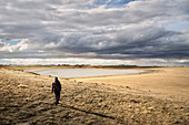 Frau wandert zur Laguna Ana, Vulkanfeld Nationalpark Pali Aike, Patagonien, Chile, Südamerika