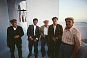 Group of local senior men standing together, Santorini, Greece