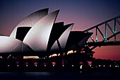 Silhouette of an opera house and bridge, Sydney Opera House, Sydney Harbor Bridge, Sydney, New South Wales, Australia