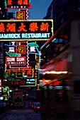 Neon signs of restaurants and stores on Nathan Road at night, Hong Kong