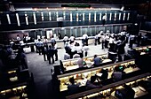 Traders working in the open floor of a stock trading center, Sydney, New South Wales, Australia