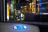A mobile on a bed in a hotel room at night