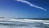 Waves rolling into shore at Burleigh Heads and Surfers Paradise in the background