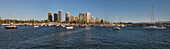 Panoramic view of Southport, Gold Coast with moored boats in front of high rise apartments taken from Marina Mirage