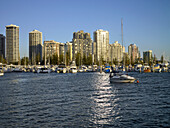 Looking from Marina Mirage across broadwater at boats moored and highrise apartment buildings in Southport