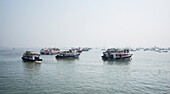 Variety of boats anchored in the water in Mubai