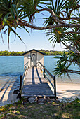 Wooden jetty and boathouse on Maroochy River