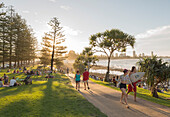 People sitting and walking at the Gold Coast Oceanway in Burleigh Heads