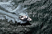 Aerial of speed boat on calm water