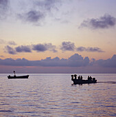 Tropical Bay at sunset with small boats on the water