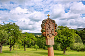 Wayside shrine with crucifixion scene in Findlos, view of the Rhön landscape