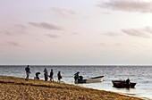 Traditionelle fidschianische Familien bereiten sich darauf vor, kleine Boote am Strand zu besteigen, um zwischen den tropischen Inseln zu reisen