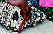 Back view of male Fijian Dancers in traditional clothing sitting on the ground