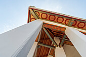 Ornate soffit of Buddhist temple against blue sky in Bangkok
