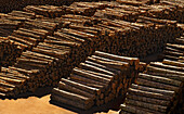 Logs stacked on wharf waiting to be exported
