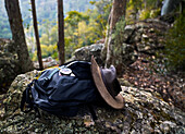 Compass, backpack and Australian akubra hat resting on a rock in the Australian bush