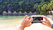 Cabanas in the Philippines, taking a photo on the phone