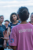 A volunteer speaks to the public to raise awareness