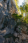 Natural Pool as the base of high rocky cliff in Springbrook National Park