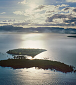 Aerial of a group of small pacific Islands and atolls off Fiji mainland at sunrise