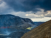 Helicopter flies over Fagradalsfjall Volcanic crater between eruptions, Iceland