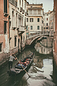 Gondolier rowing in Venice canals
