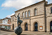 Bronze sculpture of a drummer by Tim Shaw in front of the Hall of Cornwall, Truro, England, UK