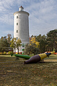 Buoys in front of Ovisu baka lighthouse, Targale, Ventspils, Latvia. lighthouse in the forest.