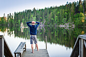 Man looks out over lake, Blekinge, Sweden