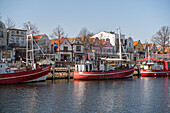 Fishing boats at the middle pier in Warnemünde in the morning.