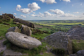 View of the valley, stones, rocks in the foreground. Curbar edge, Curbar, Peak District, England.