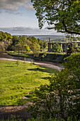 View of Bolton Abbey at River Bend. trees in the foreground. Bolton Abbey, Cavendish MemorialNorth Yorkshire, England.