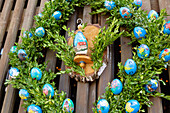 Painted Easter eggs, fountain house decorated with colorful Easter eggs with Easter crib in Birkenreuth in Franconian Switzerland, Bavaria, Germany